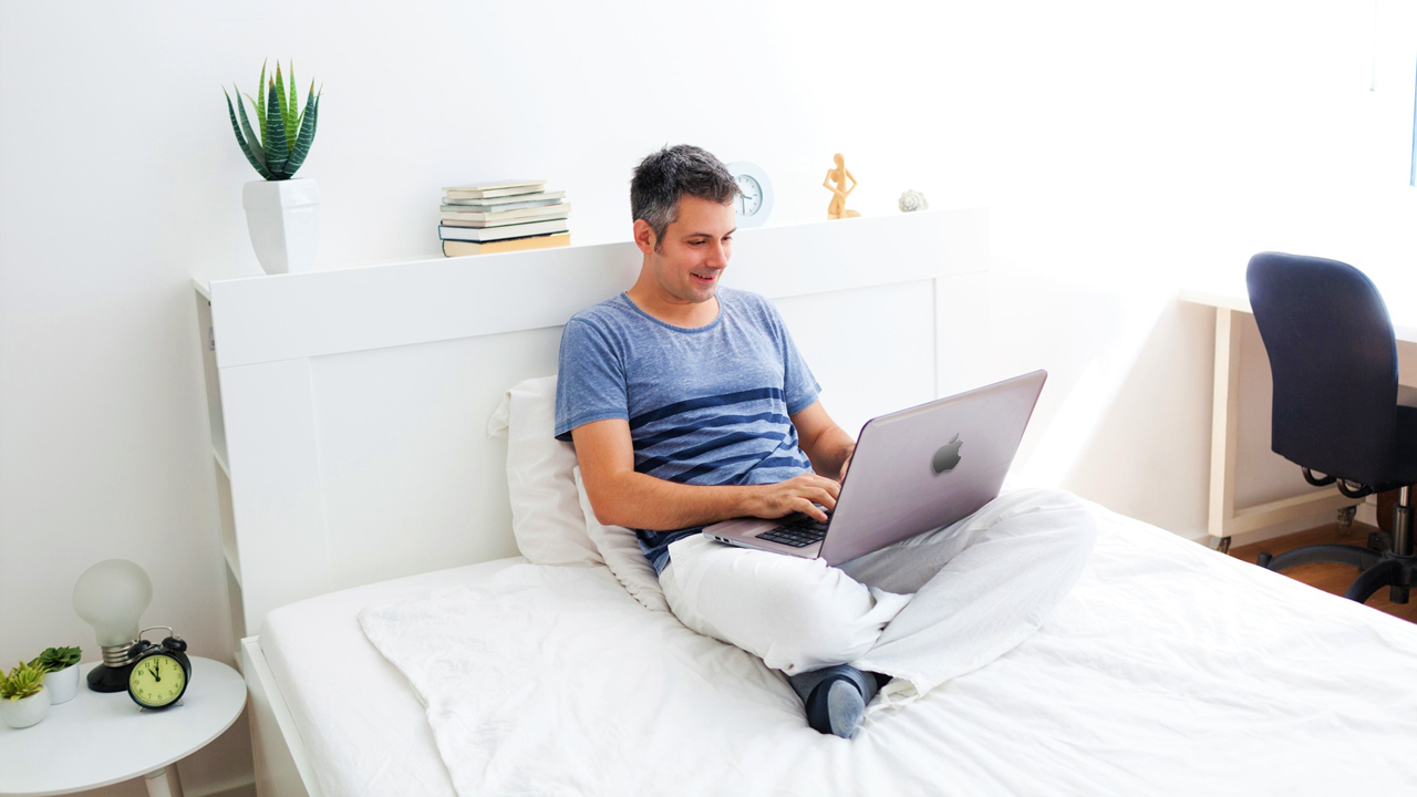 Guy working on bed with mac WESTCHASE DISTRICT